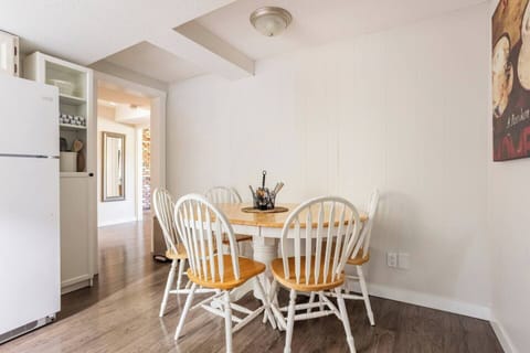 The spacious dining room is typically set up with seating for 4, but a 5th chair is available.