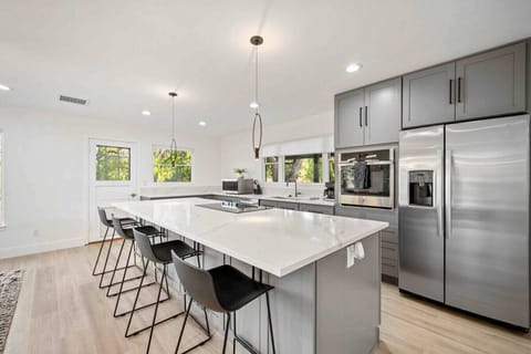 The large island in the kitchen provides barstool seating for four