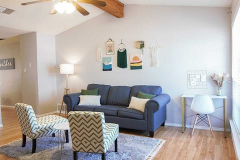 The living room offers a cozy place to unwind & a dedicated work station.