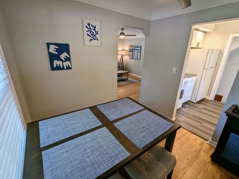Dining room between featuring a high top table with 4 padded stools.