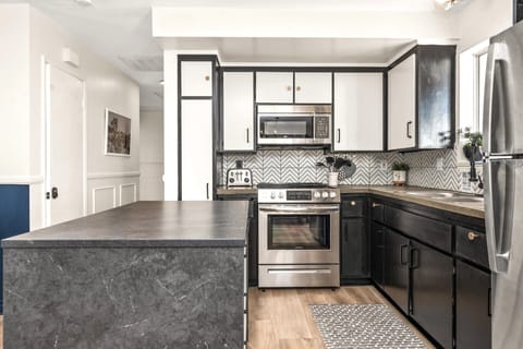 Our kitchen boasts a sleek black and white design with stainless steel appliances.