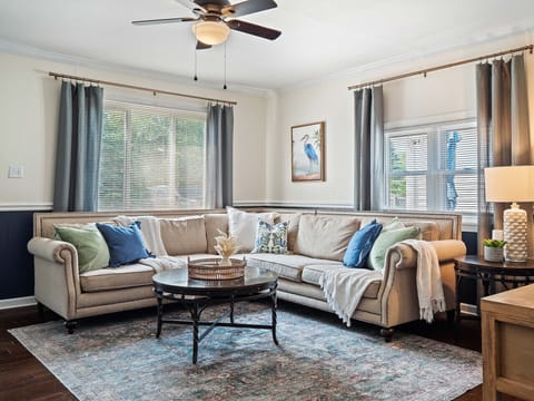 Sink into comfort in this inviting living room featuring a plush sectional, soft throws, and abundant natural light 🌿🛋️ Perfect for relaxing with a book or gathering with friends in a stylish, serene setting.