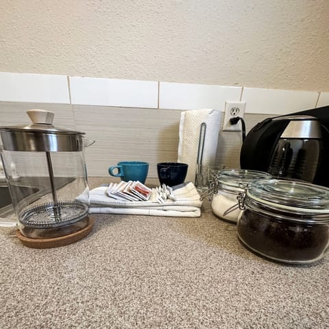 Fridge, microwave, coffee/tea maker, cookware/dishes/utensils