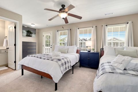 Finally, our fourth bedroom has TWO Queen-size beds, a dresser, a closet, a 50-inch Vizio Smart TV, an en suite bathroom and private access to the upstairs balcony.