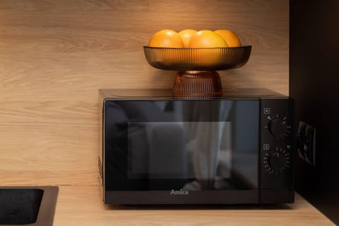 Kitchenette with oven and refrigerator. 