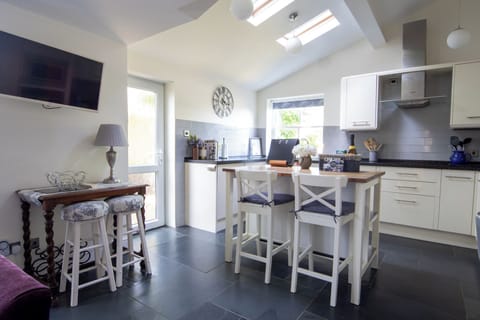 Light and airy well equipped kitchen overlooking the pretty garden.
