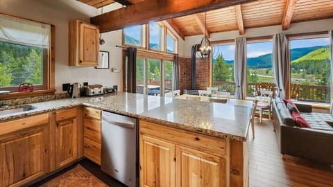 Kitchen: Drip coffee maker, blender, cooking utensils, tableware