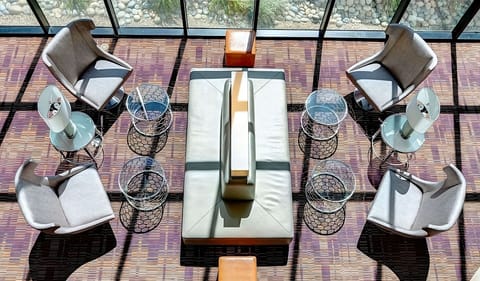 Sip coffee in sunlit lounge seating with a calm vibe.