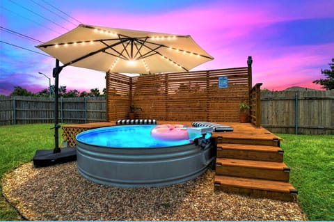Enjoy an afternoon outdoor soak in our 9 ft cowboy pool with umbrella.
