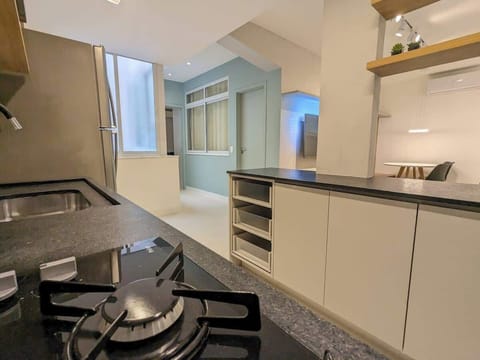 Kitchen with filtered water, pots & pans, dinnerware, silverware, and coffee maker. Entry to bedroom suite 2 in corridor to the left. Bedroom suite 1 in corridor to the right.