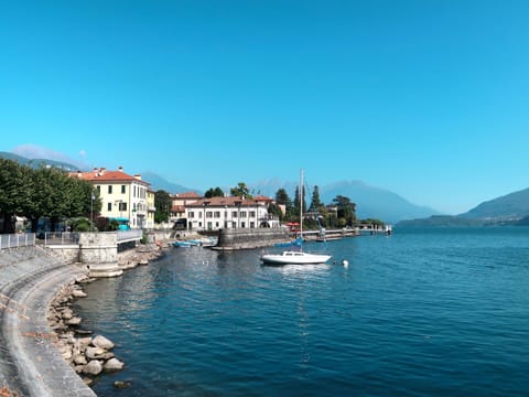 Water, Sky, Water Resources, Building, Boat, Watercraft, Azure, Mountain, Lake, Coastal And Oceanic Landforms