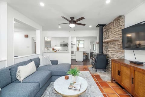 Step into sophistication in our open concept living room, where a chic sectional couch, high-tech flat screen TV, and carefully curated designer touches create a space that exudes comfort.