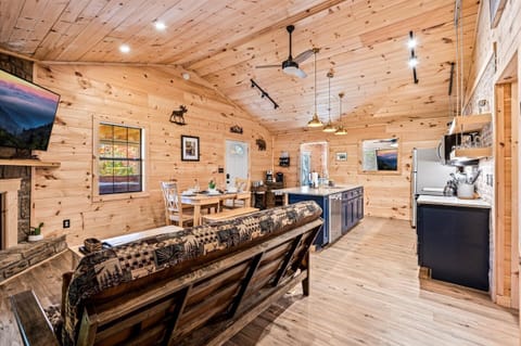 Cozy open-concept cabin living with warm wood finishes and modern flair.