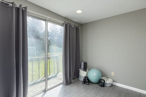 Workout area in lower level includes small equipment and blackout curtains