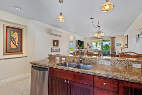 Deep double sink and stainless dishwasher offer functional space for meal prep.