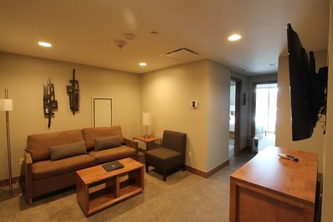 1 bedroom suite’s living area with queen sleeper sofa