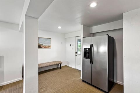 Spacious entryway with modern appliances and a cozy bench for added convenience!