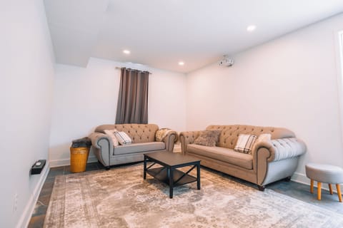 Spacious living room with 100" projector, bose sound, streaming, & large sofas.