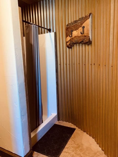 Clean. Secure. Spacious. Unique. Two full-service bathrooms in the grain bin bath house may be shared with up to 8 other guests.