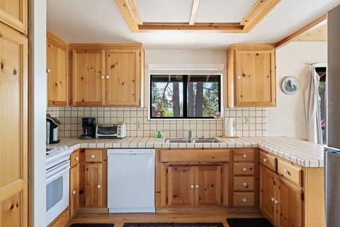 The kitchen boasts ample cabinet space, a spacious kitchen bar with seating for two, and basic cookware so you can easily whip up a delicious meal.