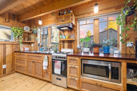 The kitchen is fully stocked and features a compact electric stove, microwave, coffee pot. 