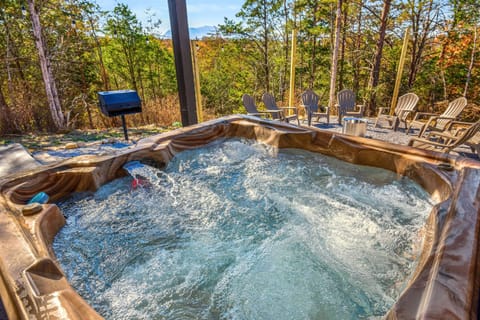 The outside patio features a luxurious hot tub, perfect for unwinding under the stars after a day of adventure.