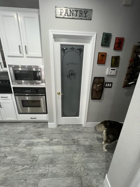 Pantry in kitchen. Microwave and oven.