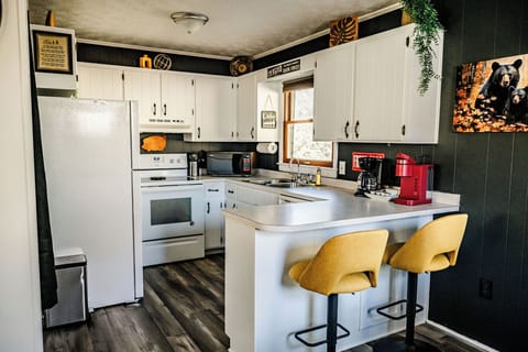 Bright and inviting kitchen with modern appliances and yellow bar stools.