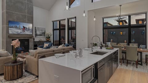 Kitchen looking into great room and deck access