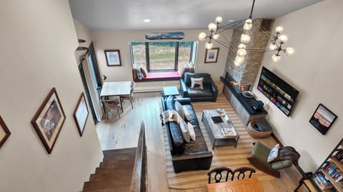 Bright open living room with spacious design and upstairs view.