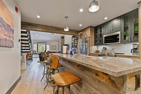 Open kitchen design flows into dining and living areas seamlessly.