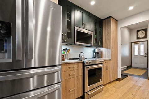 Full kitchen with stainless fridge, oven, and modern appliances.