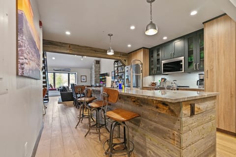 Spacious kitchen island with pendant lights, ideal for group meals.