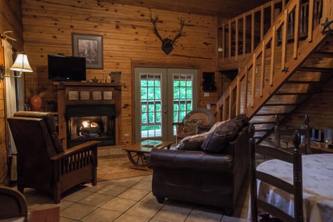 Living room, gas fireplace and french doors that open to the wrap around porch.
