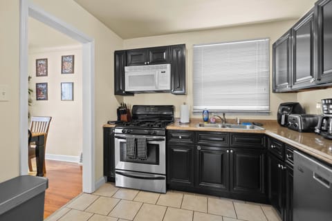 Kitchen with Air fryer, toaster, blender, microwave, coffee maker and nespresso.