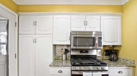 Full kitchen with all the essentials plus dishwasher and door to the patio