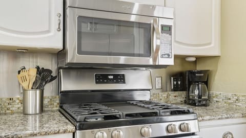 Full kitchen with all the essentials plus dishwasher and door to the patio