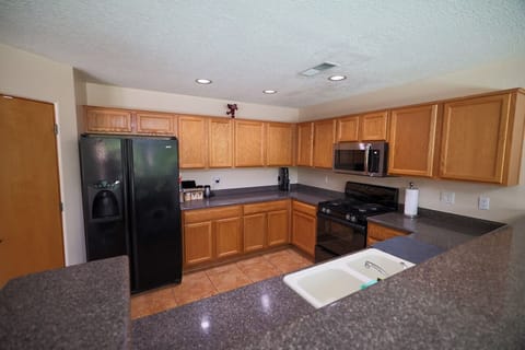 Kitchen with dishwasher, air fryer, microwave, refrigerator with ice maker, oven