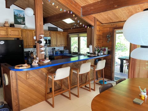 Dining area and kitchen bar with access to deck