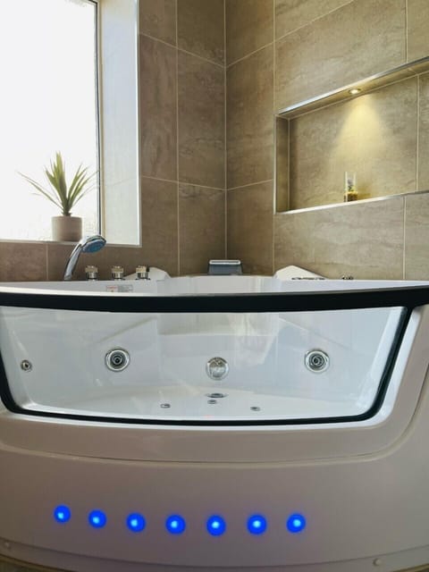 Bathtub, jetted tub, hair dryer, towels