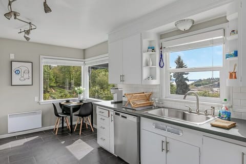 Modern kitchen with appliances and cooking essentials. 