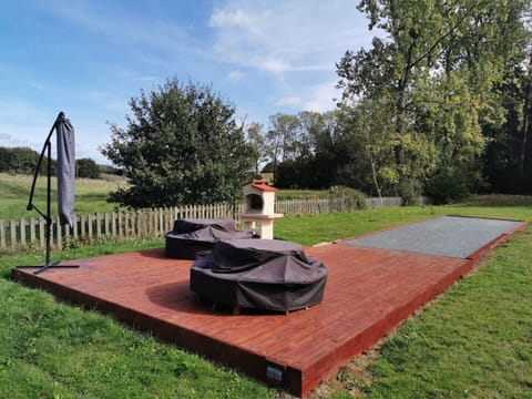 main garden - decked area with seating and bbq / pétanque terrain leading off