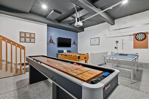 Air Force themed game room in the garage. We've got shuffleboard, ping pong, foosball, darts, boardgames and a 65" smart TV.