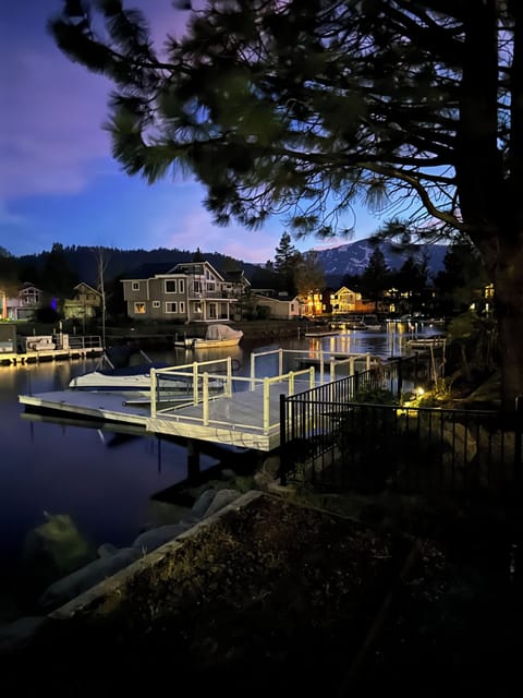 night photo of back of house and water