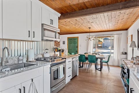 Gather around! Our cozy dining table by the kitchen is perfect for family meals and lively conversations.