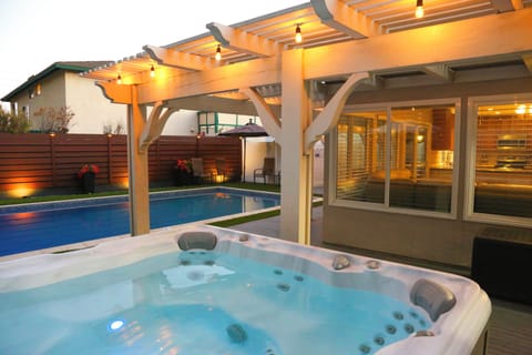 A modern pool, separate jacuzzi, and a great outdoor space!