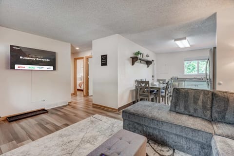 A cozy and inviting living space with plush seating, stylish decor, and an open floor plan that seamlessly connects to the kitchen—perfect for relaxing and gathering with loved ones.