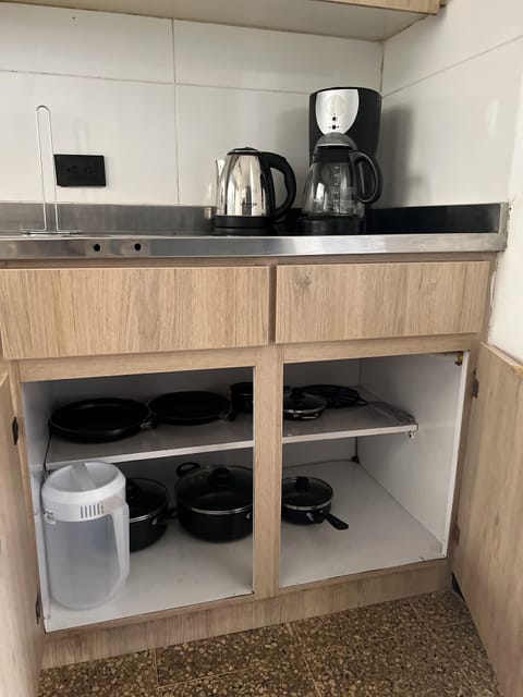 Fridge, coffee/tea maker, electric kettle, cookware/dishes/utensils