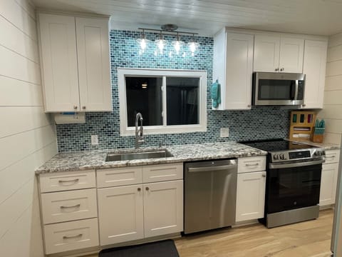 Full kitchen with dishwasher and electric stove