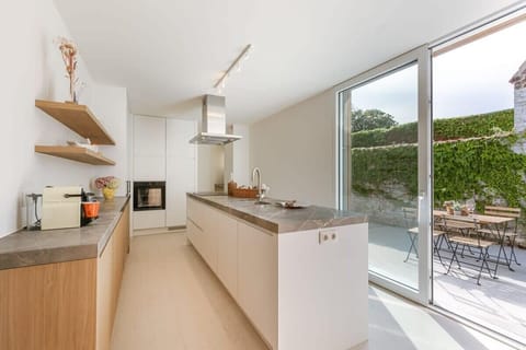 Beautiful kitchen with lots of sunlight connected to the terrace